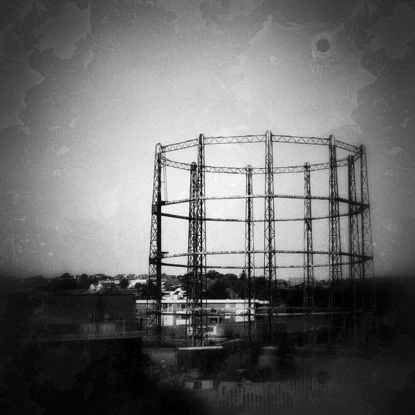 Grainy black and white photo of a steel structure from an old British gas silo structure