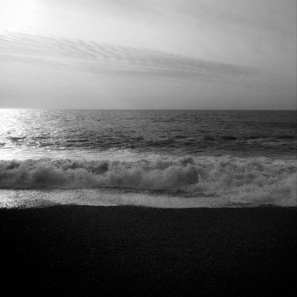 Black and white photo of sky, sea and shore