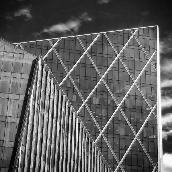 Black and white. Buildings from all dimensions,.criss-crossed like rigid webs.